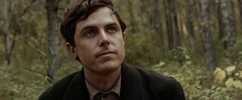 Movie still from “The Assassination of Jesse James by the Coward Robert Ford” (2007), directed by Andrew Dominik – A person wearing a suit and tie; Close Up shot, Over the shoulder angle