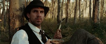 Movie still from “The Assassination of Jesse James by the Coward Robert Ford” (2007), directed by Andrew Dominik – A man holding a knife and a knife in his hand; Close Up shot, Low angle
