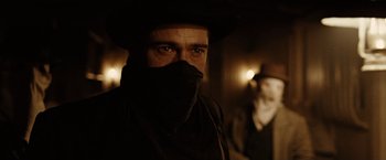 Movie still from “The Assassination of Jesse James by the Coward Robert Ford” (2007), directed by Andrew Dominik – A man in a hat and a black jacket; Close Up shot, Over the shoulder angle