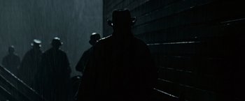 Movie still from “The Assassination of Jesse James by the Coward Robert Ford” (2007), directed by Andrew Dominik – A man wearing a hat and a black jacket; Medium shot, Low angle