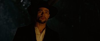 Movie still from “The Assassination of Jesse James by the Coward Robert Ford” (2007), directed by Andrew Dominik – A man wearing a black hat and a white shirt; Close Up shot, Low angle