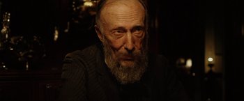 Movie still from “The Assassination of Jesse James by the Coward Robert Ford” (2007), directed by Andrew Dominik – An old man with a beard is looking at the camera; Close Up shot, Over the shoulder angle
