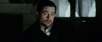 Movie still from “The Assassination of Jesse James by the Coward Robert Ford” (2007), directed by Andrew Dominik – A person wearing a jacket; Close Up shot, Over the shoulder angle