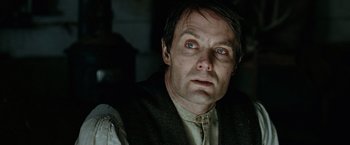 Movie still from “The Assassination of Jesse James by the Coward Robert Ford” (2007), directed by Andrew Dominik – A person wearing a suit and tie; Close Up shot, Low angle