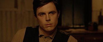 Movie still from “The Assassination of Jesse James by the Coward Robert Ford” (2007), directed by Andrew Dominik – A person wearing a suit and tie; Close Up shot, Over the shoulder angle