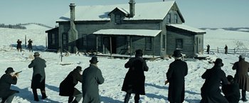 Movie still from “The Assassination of Jesse James by the Coward Robert Ford” (2007), directed by Andrew Dominik – A group of people standing on top of a snow covered ground; Extreme Wide shot, High angle