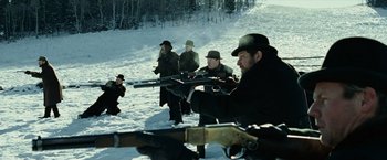 Movie still from “The Assassination of Jesse James by the Coward Robert Ford” (2007), directed by Andrew Dominik – A group of people in the snow with rifles; Medium shot, Low angle