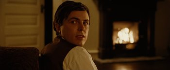 Movie still from “The Assassination of Jesse James by the Coward Robert Ford” (2007), directed by Andrew Dominik – A young man in a white shirt and a brown vest; Close Up shot, Over the shoulder angle