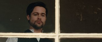 Movie still from “The Assassination of Jesse James by the Coward Robert Ford” (2007), directed by Andrew Dominik – A person looking out of a window; Close Up shot, Low angle