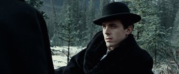 Movie still from “The Assassination of Jesse James by the Coward Robert Ford” (2007), directed by Andrew Dominik – A man wearing a black hat and a black coat; Close Up shot, Low angle