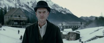 Movie still from “The Assassination of Jesse James by the Coward Robert Ford” (2007), directed by Andrew Dominik – A man wearing a black hat and a black jacket; Close Up shot, Low angle