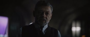 Movie still from “The Batman” (2022), directed by Matt Reeves – An older man wearing a vest and a tie; Close Up shot, Over the shoulder angle