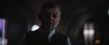 Movie still from “The Batman” (2022), directed by Matt Reeves – An older man wearing a vest and a tie; Close Up shot, Over the shoulder angle