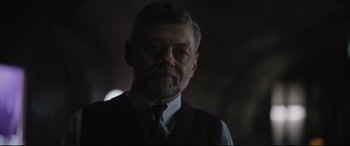 Movie still from “The Batman” (2022), directed by Matt Reeves – A person wearing a suit and tie; Close Up shot, Over the shoulder angle