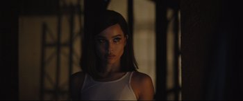 Movie still from “The Batman” (2022), directed by Matt Reeves – A beautiful young woman with long dark brown hair; Close Up shot, Over the shoulder angle