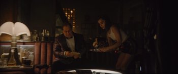 Movie still from “The Batman” (2022), directed by Matt Reeves – A man and a woman are playing a card game together; Medium shot, Over the shoulder angle