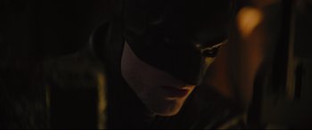 Movie still from “The Batman” (2022), directed by Matt Reeves – A person wearing a batman mask; Close Up shot, Low angle