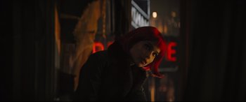 Movie still from “The Batman” (2022), directed by Matt Reeves – A woman with red hair standing on a city street at night; Close Up shot, Over the shoulder angle