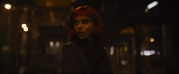 Movie still from “The Batman” (2022), directed by Matt Reeves – A woman with red hair is standing in the dark; Close Up shot, Over the shoulder angle
