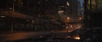 Movie still from “The Batman” (2022), directed by Matt Reeves – A city street at night lit by street lights; Extreme Wide shot, High angle
