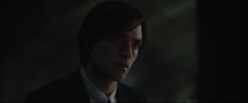 Movie still from “The Batman” (2022), directed by Matt Reeves – A person wearing a suit and tie; Close Up shot, Over the shoulder angle