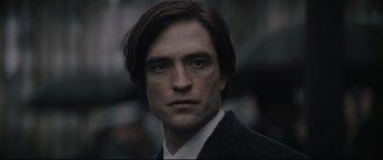 Movie still from “The Batman” (2022), directed by Matt Reeves – A person wearing a suit and tie; Close Up shot, Over the shoulder angle