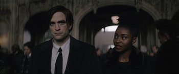 Movie still from “The Batman” (2022), directed by Matt Reeves – A man and a woman standing next to each other in a hallway; Close Up shot, Over the shoulder angle