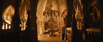 Movie still from “The Batman” (2022), directed by Matt Reeves – A room filled with furniture and a table in it; Extreme Wide shot, Low angle