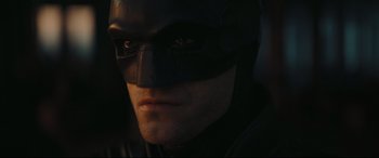 Movie still from “The Batman” (2022), directed by Matt Reeves – A person wearing a batman mask; Close Up shot, Low angle