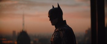 Movie still from “The Batman” (2022), directed by Matt Reeves – A person wearing a batman costume; Medium shot, Low angle