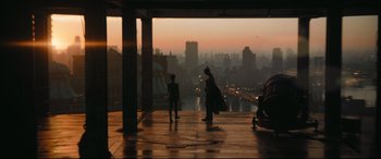 Movie still from “The Batman” (2022), directed by Matt Reeves – Two people standing on a balcony overlooking a city skyline; Extreme Wide shot, Over the shoulder angle