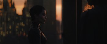 Movie still from “The Batman” (2022), directed by Matt Reeves – A woman standing in a dark room with the sun setting behind her; Close Up shot, Low angle