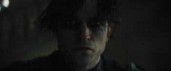 Movie still from “The Batman” (2022), directed by Matt Reeves – A person's face in the dark; Close Up shot, Low angle