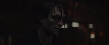 Movie still from “The Batman” (2022), directed by Matt Reeves – A person with wet hair; Close Up shot, Over the shoulder angle