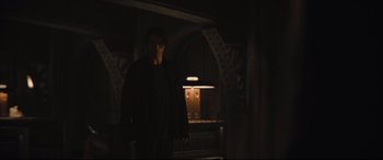Movie still from “The Batman” (2022), directed by Matt Reeves – A man standing in the dark in a room; Wide shot, Over the shoulder angle