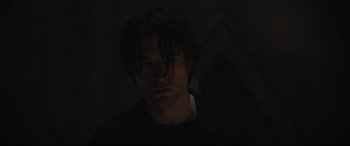 Movie still from “The Batman” (2022), directed by Matt Reeves – A man with long hair is looking at the camera; Close Up shot, Low angle