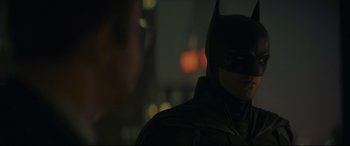 Movie still from “The Batman” (2022), directed by Matt Reeves – A person wearing a batman mask; Close Up shot, Over the shoulder angle