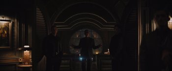 Movie still from “The Batman” (2022), directed by Matt Reeves – A group of men standing in a dark room; Wide shot, Low angle