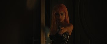 Movie still from “The Batman” (2022), directed by Matt Reeves – A woman with pink hair is holding a gun; Close Up shot, Over the shoulder angle