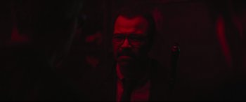 Movie still from “The Batman” (2022), directed by Matt Reeves – A man in a suit and tie in a dark room; Close Up shot, Over the shoulder angle