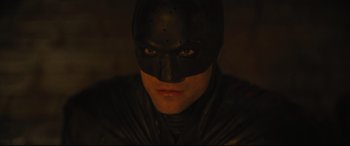 Movie still from “The Batman” (2022), directed by Matt Reeves – A person wearing a batman mask; Close Up shot, High angle