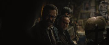 Movie still from “The Batman” (2022), directed by Matt Reeves – A man in a suit and tie standing next to another man in a suit and tie; Close Up shot, Over the shoulder angle