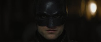 Movie still from “The Batman” (2022), directed by Matt Reeves – A person wearing a batman mask; Close Up shot, Low angle