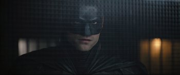 Movie still from “The Batman” (2022), directed by Matt Reeves – A person wearing a batman mask; Close Up shot, Low angle