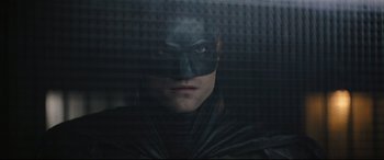 Movie still from “The Batman” (2022), directed by Matt Reeves – A person wearing a batman mask; Close Up shot, Low angle