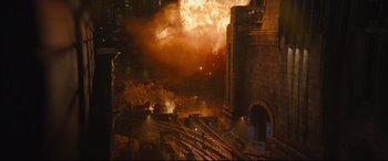 Movie still from “The Batman” (2022), directed by Matt Reeves – A train is going down the tracks in a city; Extreme Wide shot, High angle