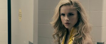Movie still from “The Boys” (2019), created by Eric Kripke – A woman with long blonde hair wearing a yellow jacket; Close Up shot, Over the shoulder angle