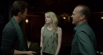 Movie still from “Birdman or (The Unexpected Virtue of Ignorance)” (2014), directed by Alejandro G. Iñárritu – A woman standing next to two men in a theater; Medium shot, Over the shoulder angle