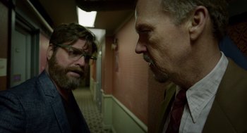 Movie still from “Birdman or (The Unexpected Virtue of Ignorance)” (2014), directed by Alejandro G. Iñárritu – Two men are talking in a hallway of a building; Medium shot, Over the shoulder angle