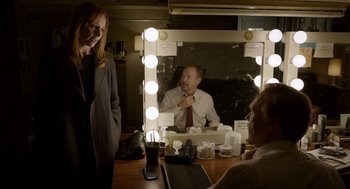 Movie still from “Birdman or (The Unexpected Virtue of Ignorance)” (2014), directed by Alejandro G. Iñárritu – A woman standing in front of a man in front of a mirror; Medium shot, Over the shoulder angle